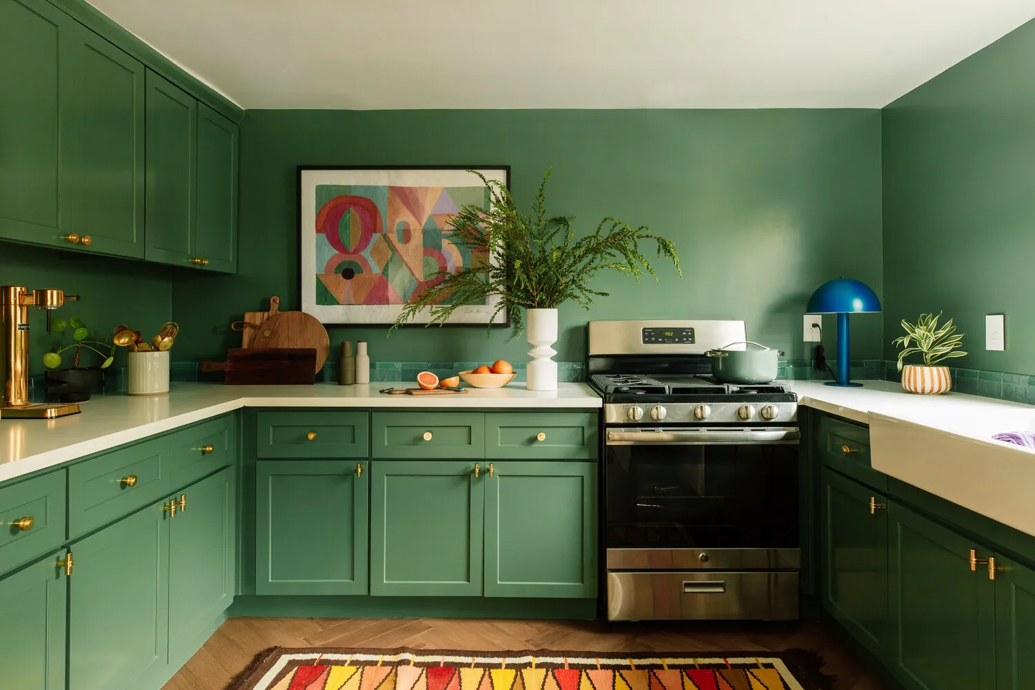 deep emerald green cabinets with gold hardware