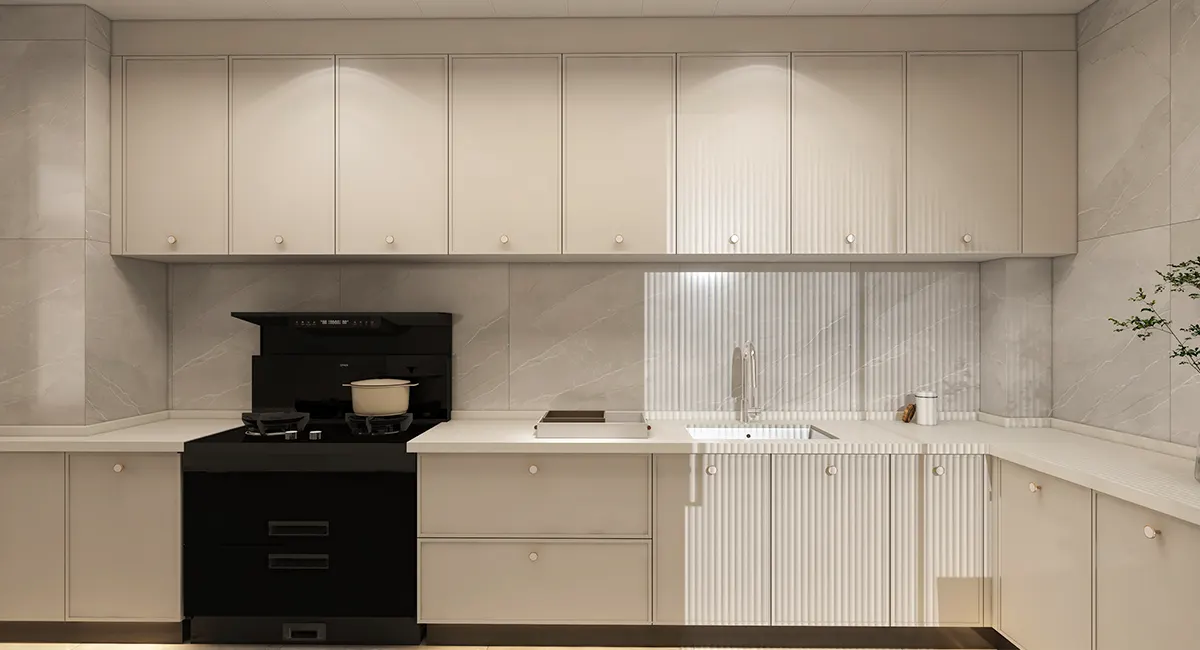 matte light grey L-shaped kitchen cabinets with dot knobs