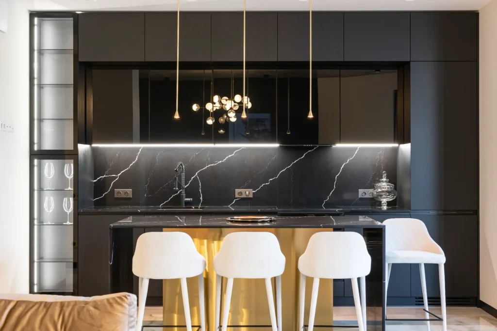 contemporary black kitchen cabinets with black countertop and gold island